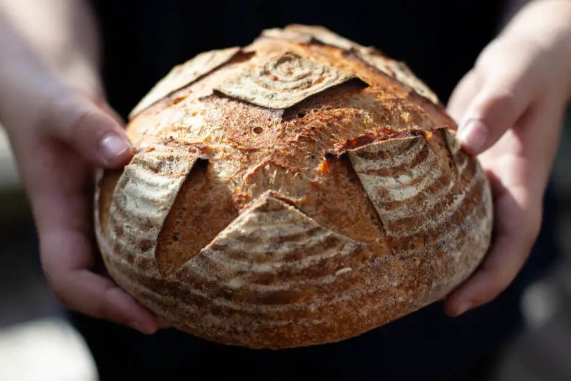 Tom holds freshly baked sourdough bread