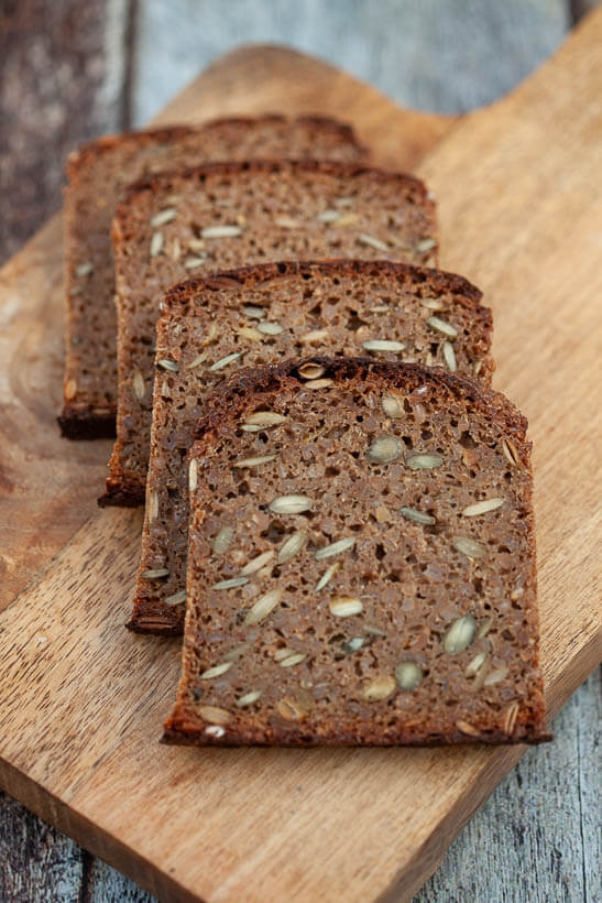 The bread's recipe was developed using baker's math. 100% sourdough rye bread on a cutting board. 