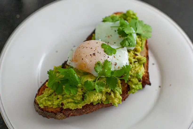 smashed avocado with poached egg sourdough sandwich 
