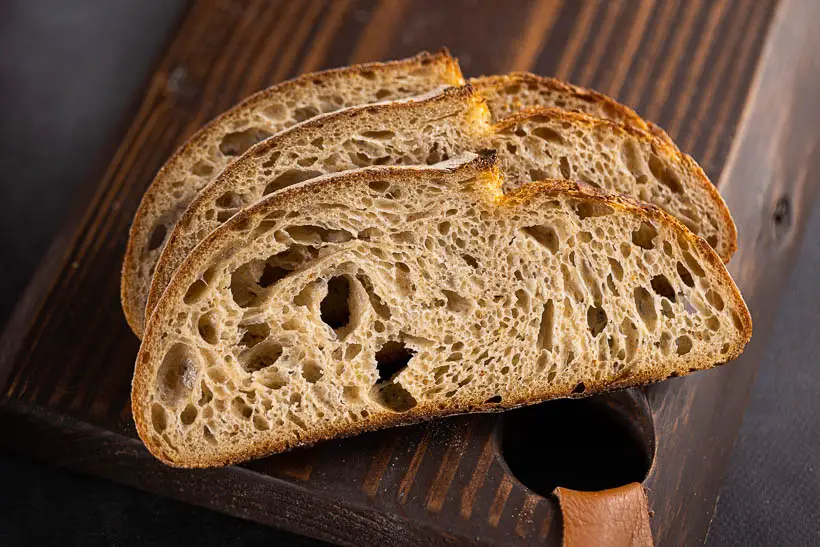 high hydration sourdough bread recipe with tangzhong - gorgeous crumb on a cutting board