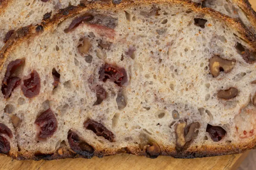 close up of the crumb in this sourdough walnut cranberry bread
