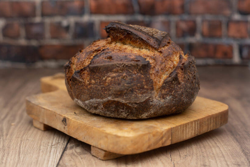 a jewish sourdough rye bread boule on a board