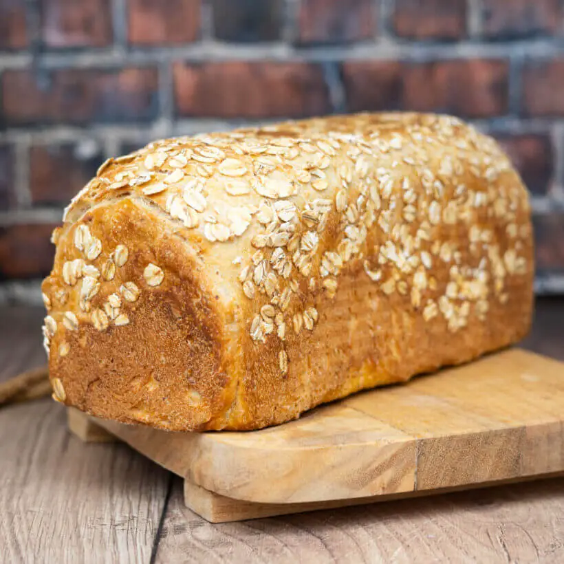honey oat sandwich sourdough bread on a board