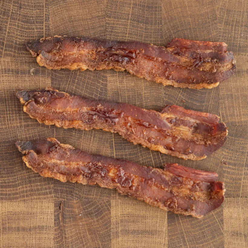 Thick strips of bacon baked in the oven on a rack